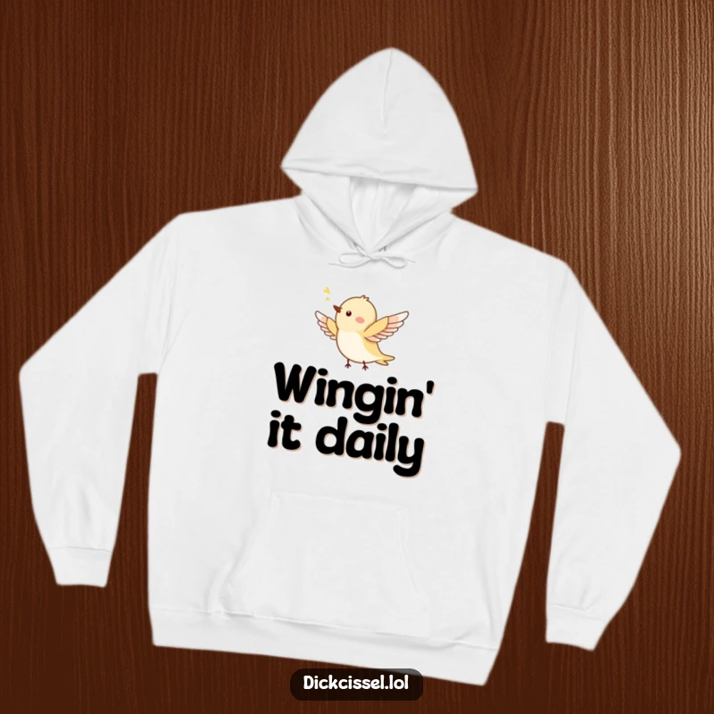 Funny hoodie showcasing a tiny, jubilant bird soaring through the air, wings elegantly spread, embodying joy. A cozy graphic.