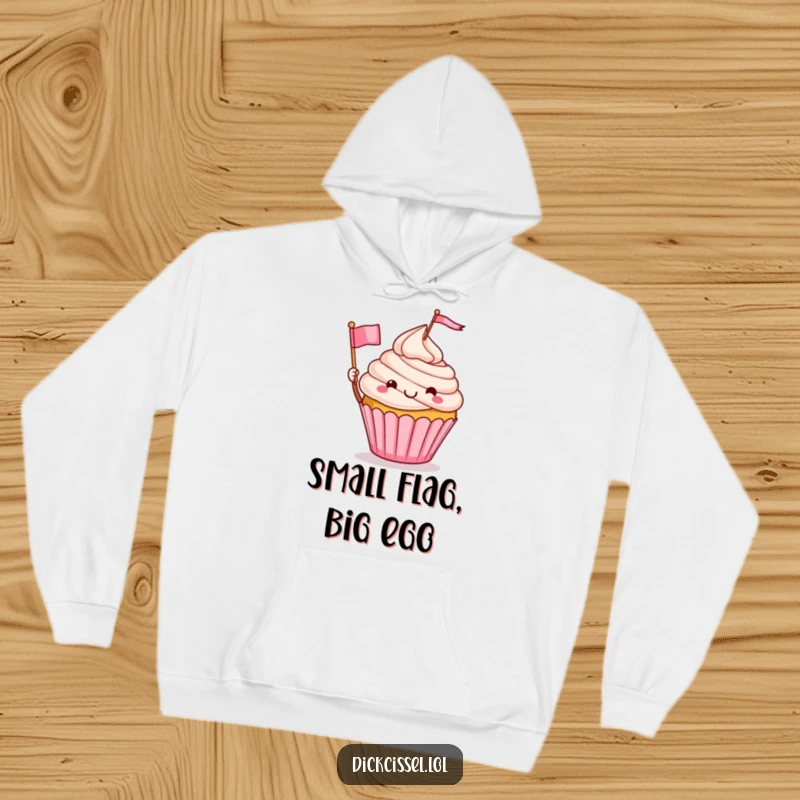 Funny hoodie featuring a smiling cupcake character triumphantly waving a tiny flag, radiating joy and warmth, an excellent funny gift.